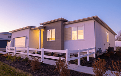 Image of a beautiful white and gray model home with a front yard