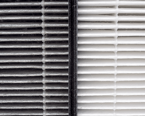 Image of a white and a black HVAC filter